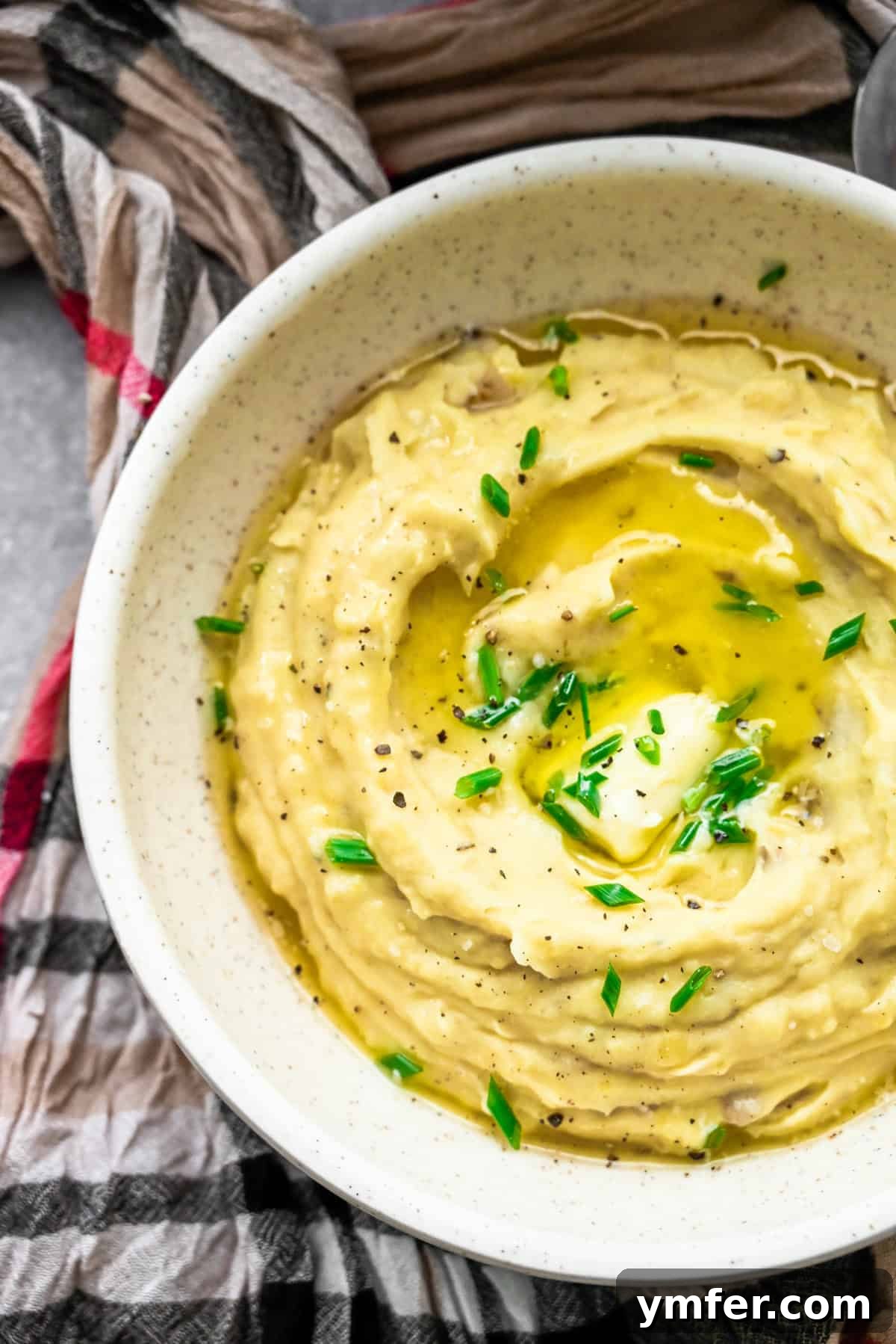 A Feast of Thanksgiving Sides 3 Creamy Instant Pot mashed potatoes topped with chives in a serving bowl.