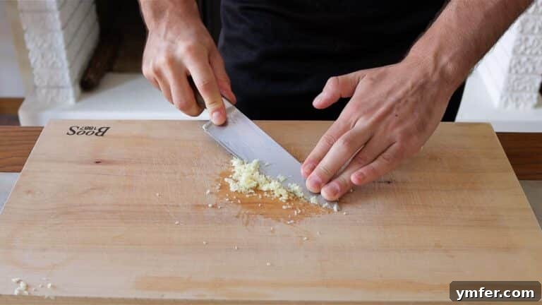 mashing garlic