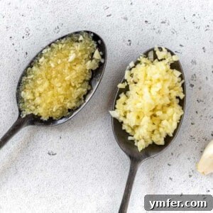 minced garlic on black spoons