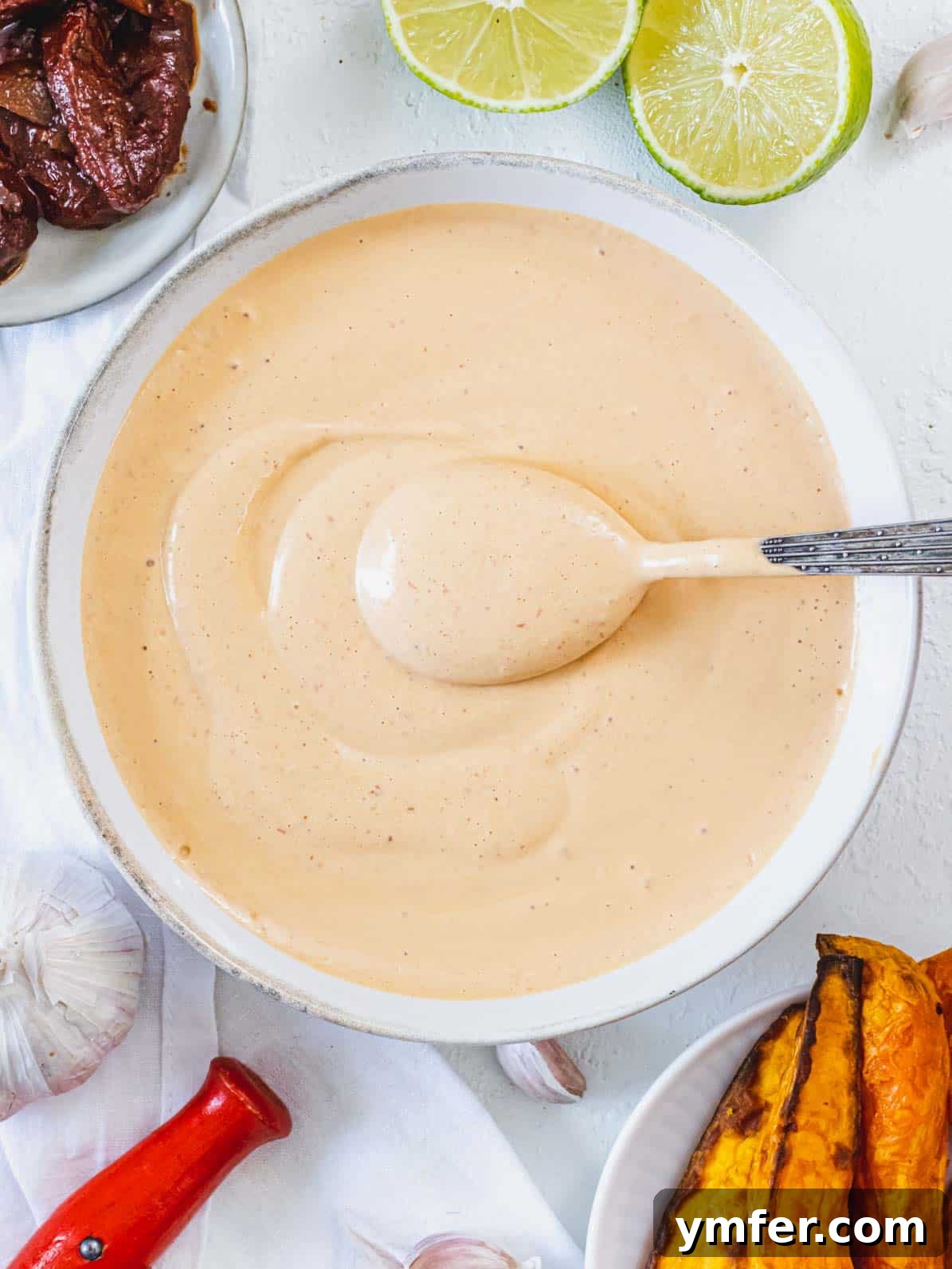 Smoky Chipotle Sauce 2 Chipototle sauce in a bowl with a spoon, showcasing its rich, creamy texture.