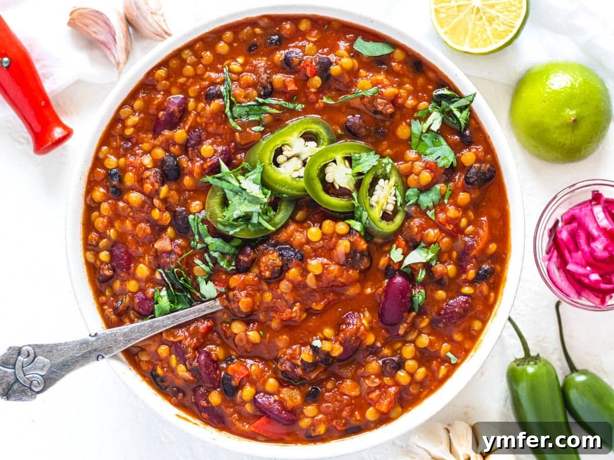 30 Easy Fall Meals 3 Lentil chili in a bowl with pickled jalapenos and a spoon, ready to be stored