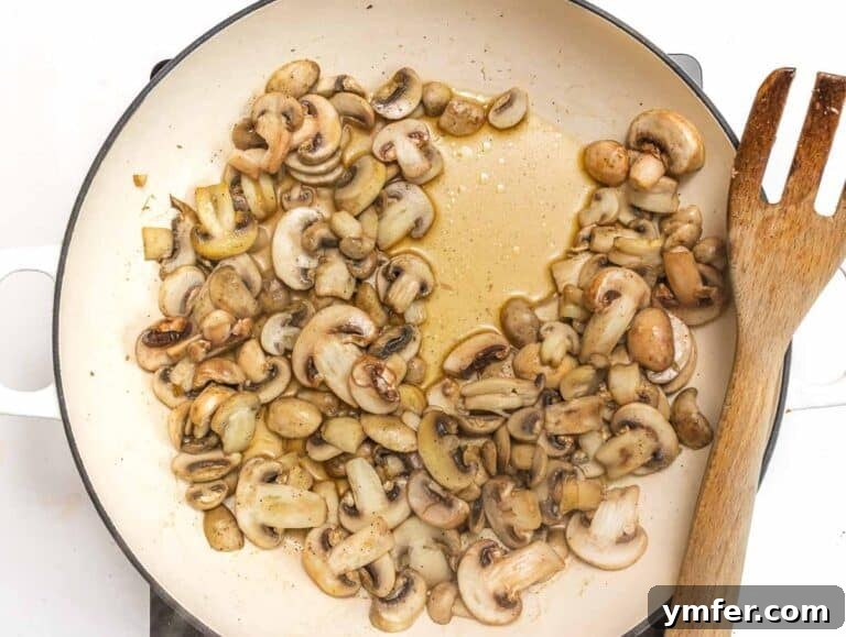 Mushrooms browning in a hot skillet