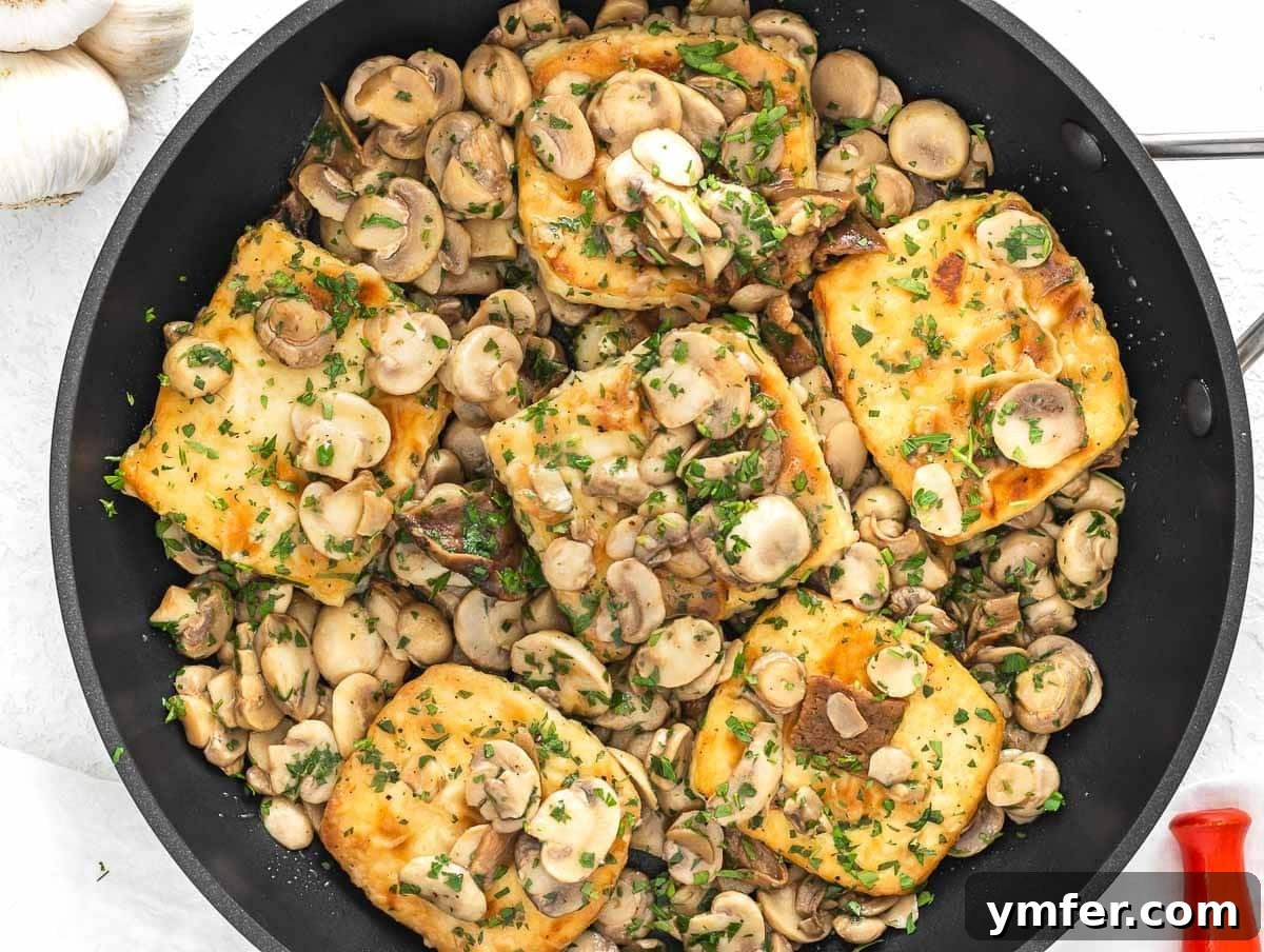 Flavorful Tofu Mushroom Medley 3 Tofu and mushrooms simmering in a pan, coated in a rich, creamy sauce.