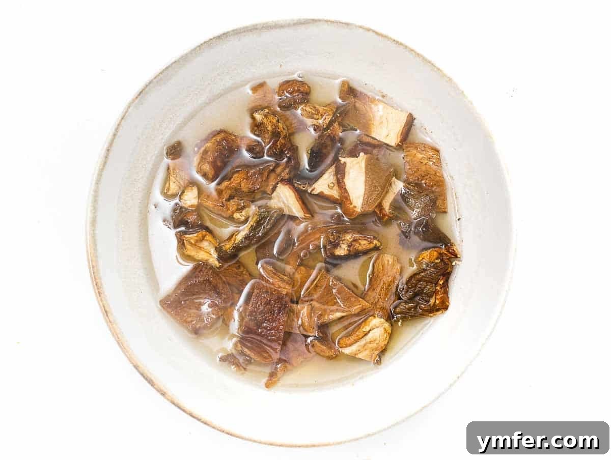 Flavorful Tofu Mushroom Medley 6 Dried porcini mushrooms soaking in a bowl of hot water.