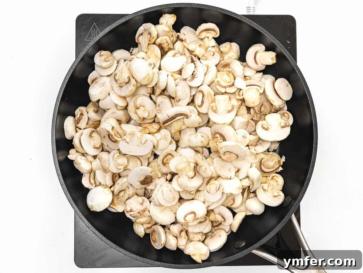 Flavorful Tofu Mushroom Medley 7 Fresh mushrooms and garlic cooking in olive oil in a skillet.