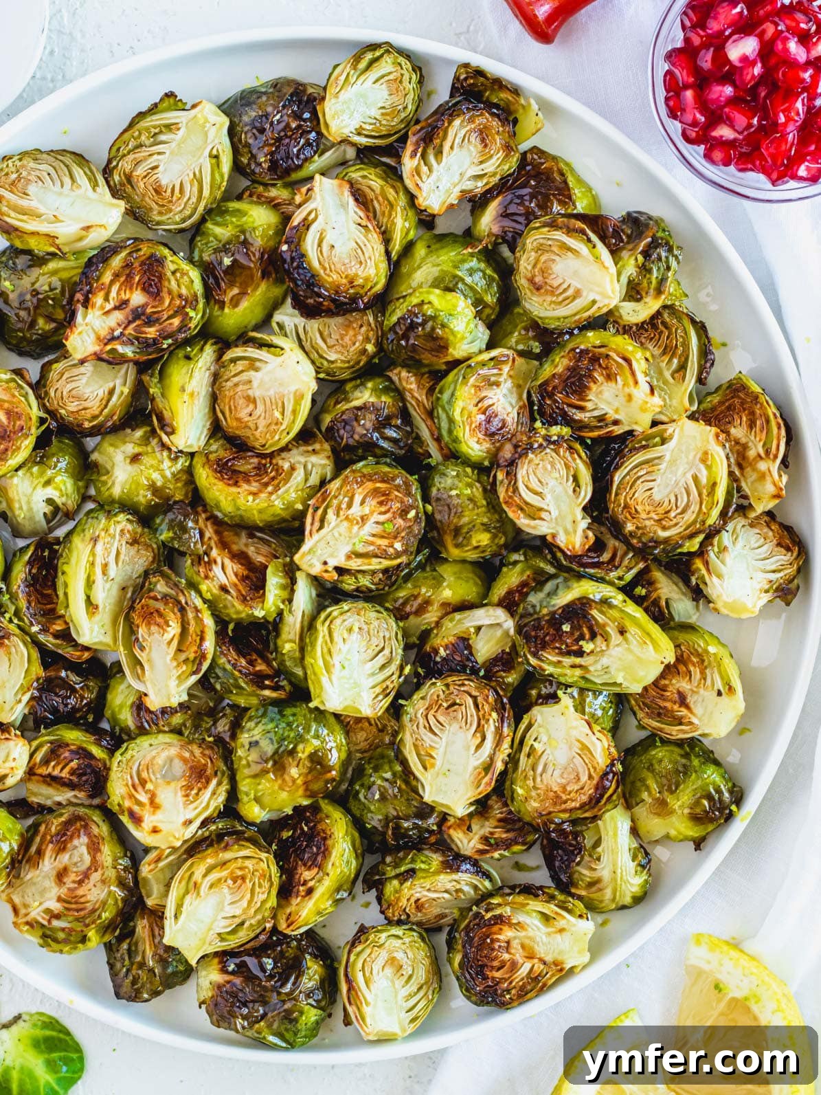 Crispy Roasted Brussels Sprouts 2 Roasted Brussels sprouts on a round plate, ready to be served as a delicious side dish.