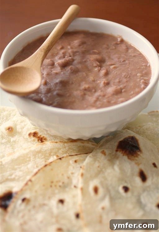 Down Home Pinto Beans 2 These Southern style pinto beans only take 4 ingredients and cost less than $5 to make! They are perfect eaten plain or rolled up in a soft flour tortilla.