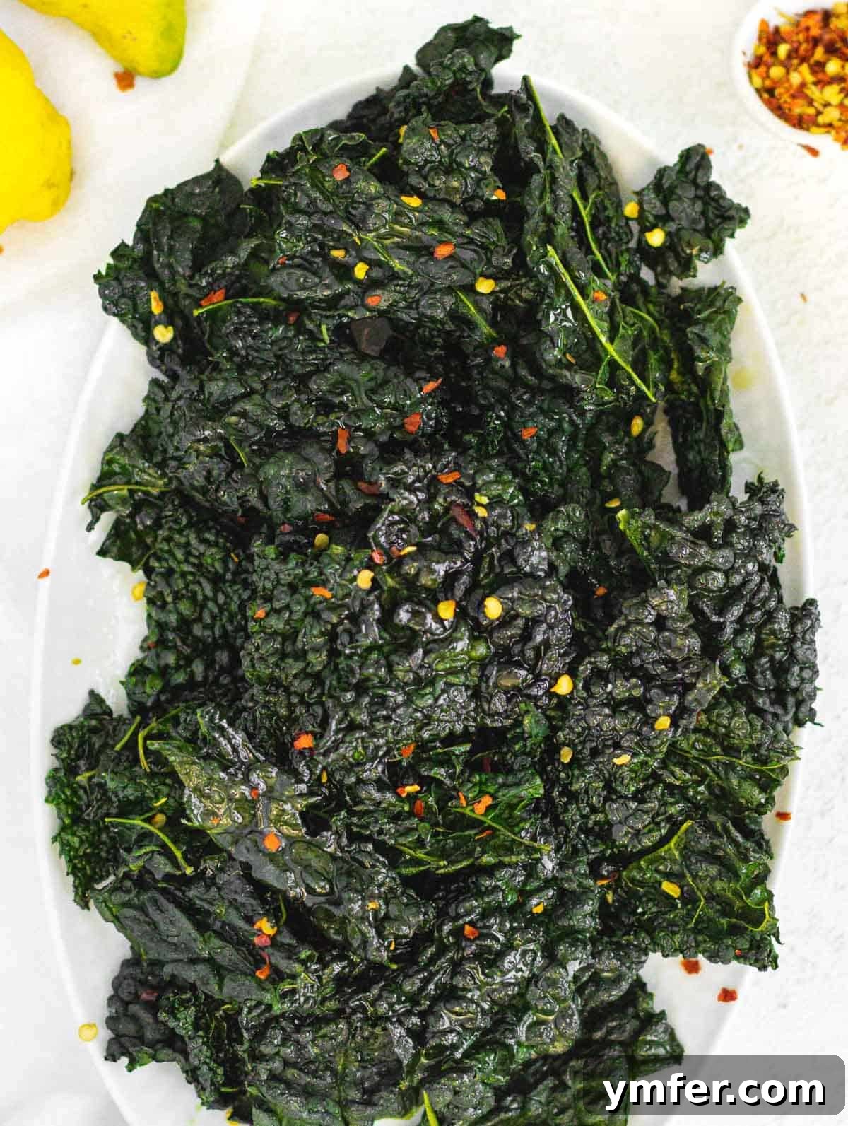 Kale Crunch 2 Crispy Kale chips garnished with fresh lemon zest and red pepper flakes