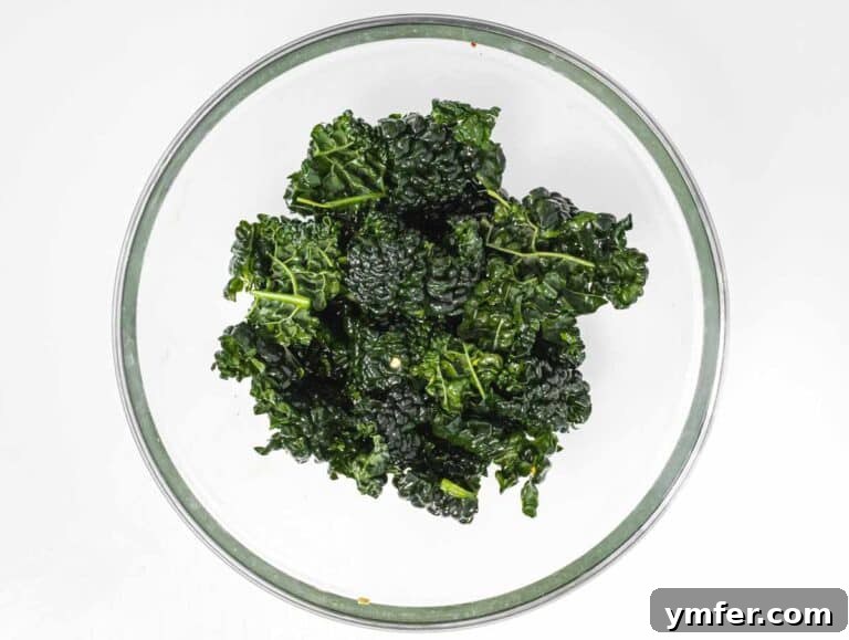 Kale Crunch 15 Kale pieces tossed with oil in a bowl