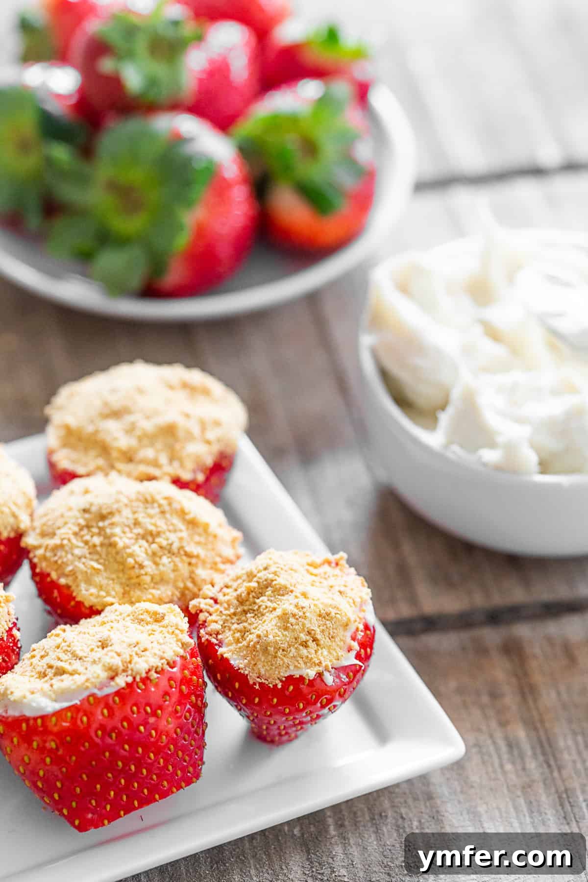 Strawberry Cheesecake Bliss Bites 4 Cheesecake Stuffed Strawberries on a serving platter.