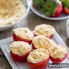 These cheesecake stuffed strawberries are simple to make and perfect for Valentine's Day. Stuffed with sweet cream cheese filling and topped with a dusting of graham cracker crumbs.