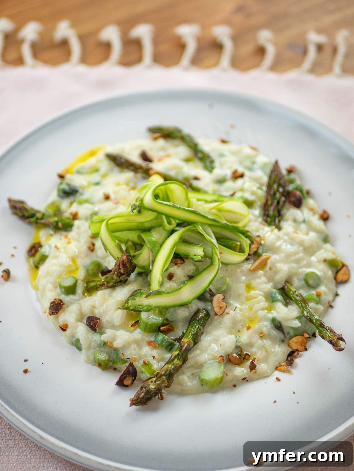 Effortless Plant-Based Risotto 16 Beautifully plated vegan asparagus risotto with fresh green garnishes.