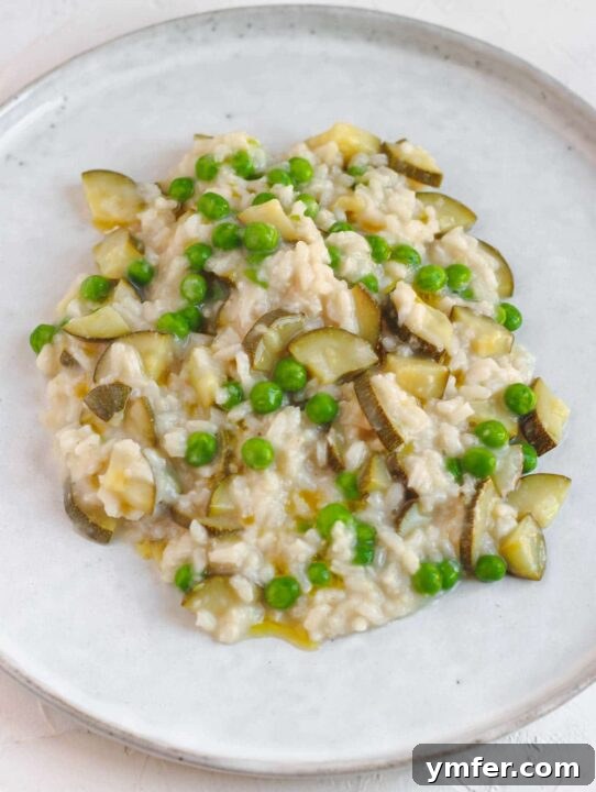 Effortless Plant-Based Risotto 3 Creamy vegan zucchini risotto, garnished with fresh herbs.