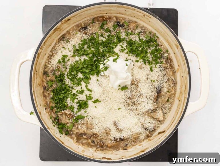 Effortless Plant-Based Risotto 23 Adding parsley and vegan butter to a casserole of risotto.