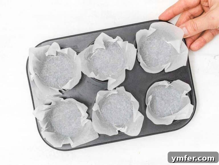 Wholesome Chickpea Egg Muffins 17 muffin pan with baking paper and a hand