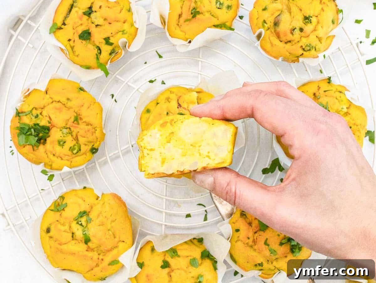 Wholesome Chickpea Egg Muffins 6 Chickpea Muffins cut in half with cauliflower and a hand