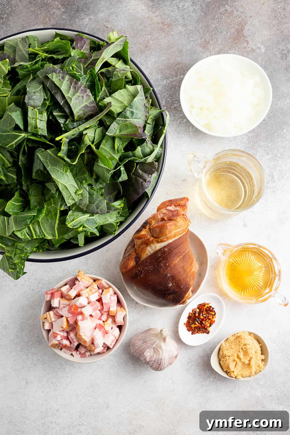 Flavorful Instant Pot Collard Greens 3 Collard greens, ham hock, bacon, apple cider vinegar, chicken stock, brown sugar, garlic, and red pepper flakes sitting on a table.