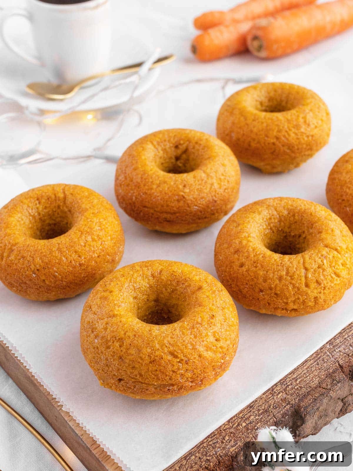 Dolce Carota Cake 19 A tray of freshly baked carrot cake donuts, golden and inviting.