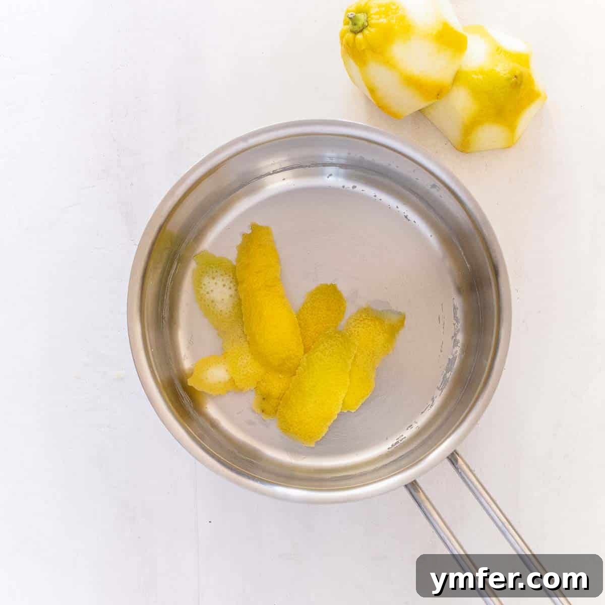 Zesty Plant-Based Lemon Squares 13 Lemon peel simmering in a saucepan with other ingredients to infuse flavor.