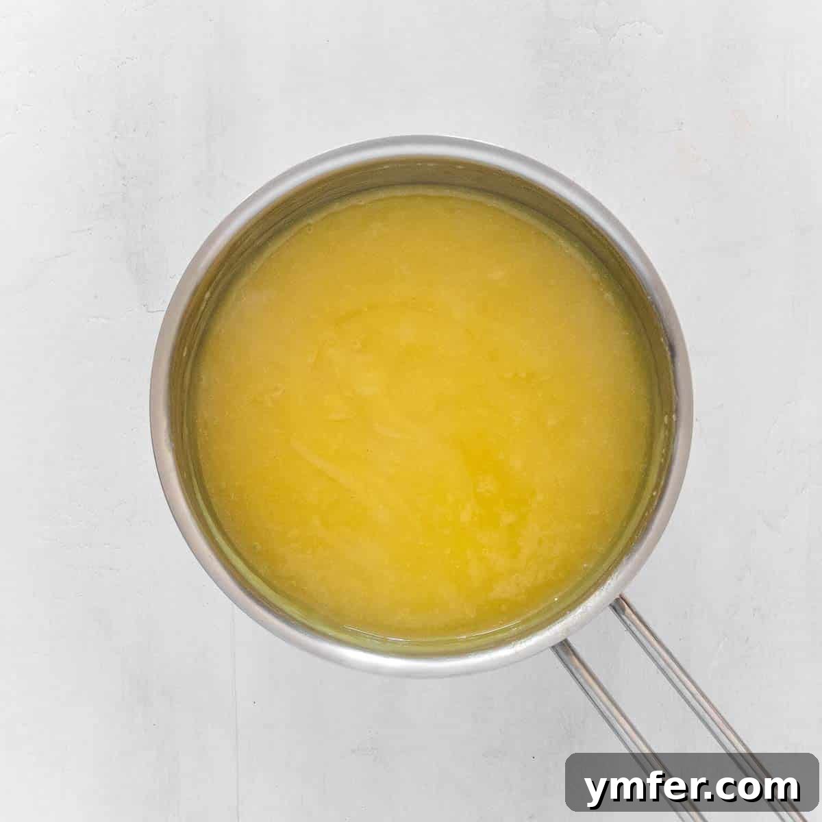 Zesty Plant-Based Lemon Squares 16 Creamy vegan lemon curd simmering in a saucepan, thickened to perfection.