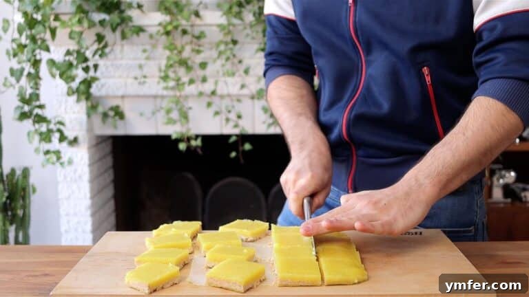 Zesty Plant-Based Lemon Squares 38 cutting vegan lemon bars