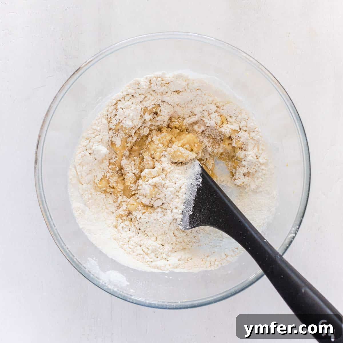 Zesty Plant-Based Lemon Squares 8 Sifting dry ingredients – flour and baking powder – into the bowl for the crust.