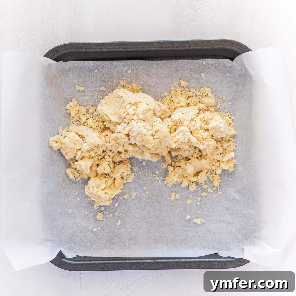 Zesty Plant-Based Lemon Squares 10 The vegan pie crust pressed firmly into the lined baking tray, ready for a quick bake.