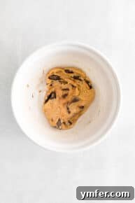 Chocolate chunks being folded into the cookie dough.