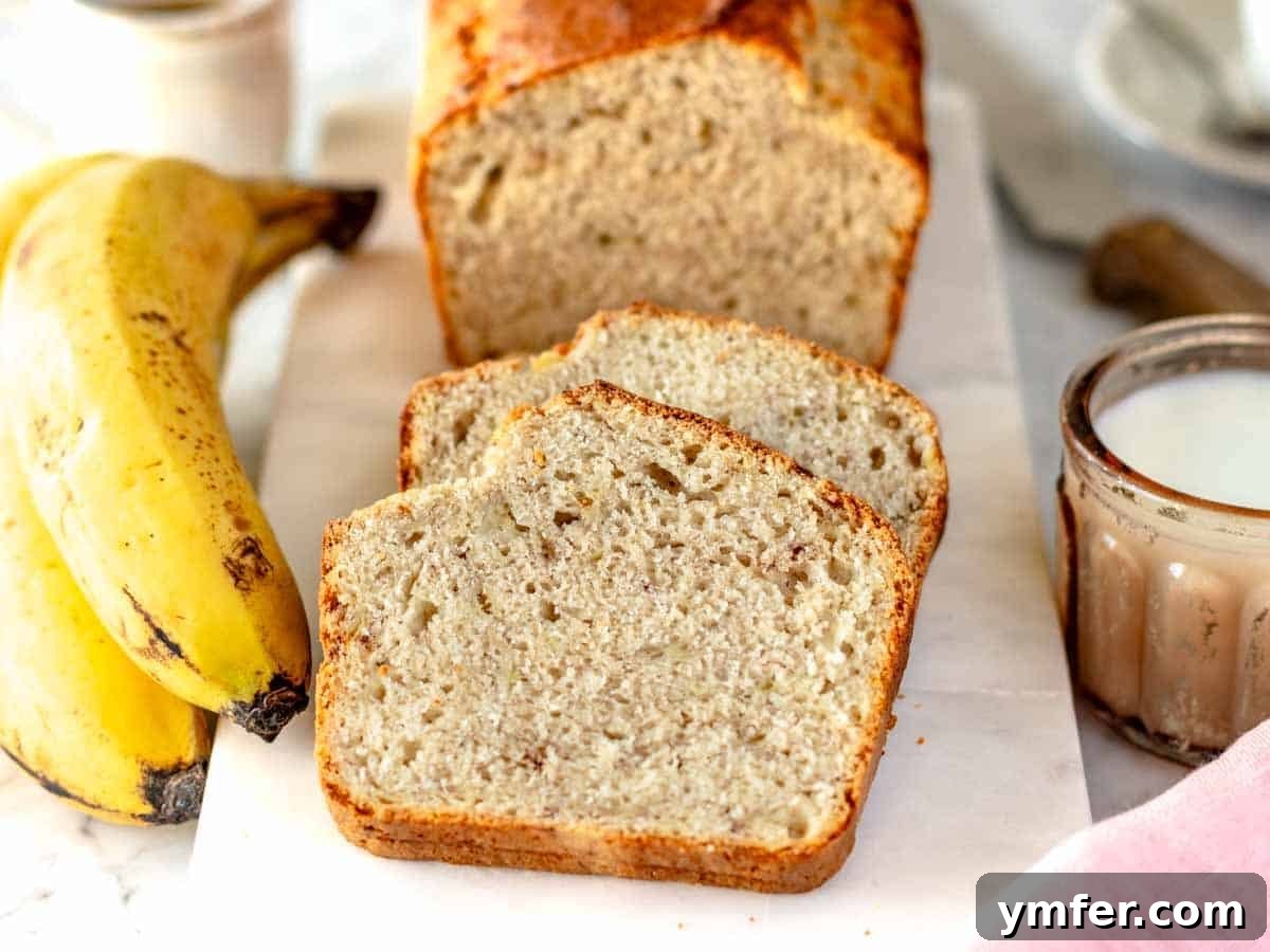 Plant-Powered Banana Bread Perfection 7 Two generous slices of vegan banana bread resting on a marble cutting board