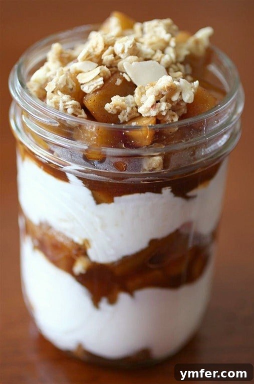 Delicious Maple Apple Yogurt Parfait layered with creamy yogurt, spiced apples, and crunchy granola, perfect for a fall breakfast or dessert.