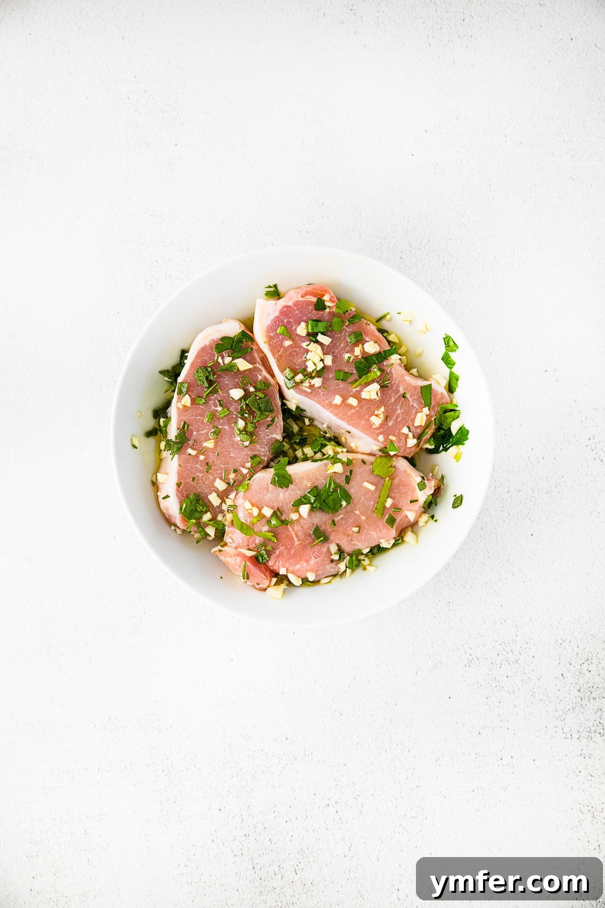 Marinating pork chops in a bowl. 