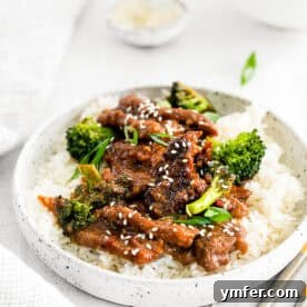 Instant Pot Mongolian Beef in a bowl with rice and broccoli.
