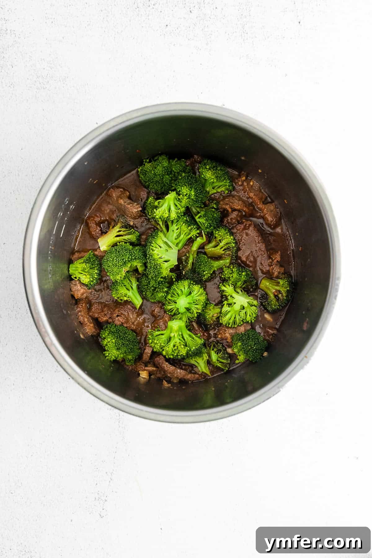 Speedy Instant Pot Mongolian Beef 4 Mongolian beef simmering in the Instant Pot, showing the tender beef and rich sauce.