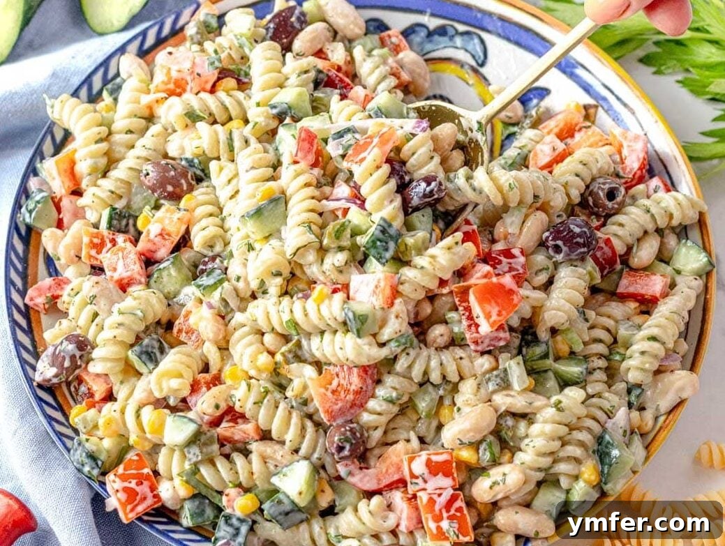 35 Stress-Free Dinner Recipes 9 Creamy pasta salad served on a stylish blue plate, garnished with fresh herbs