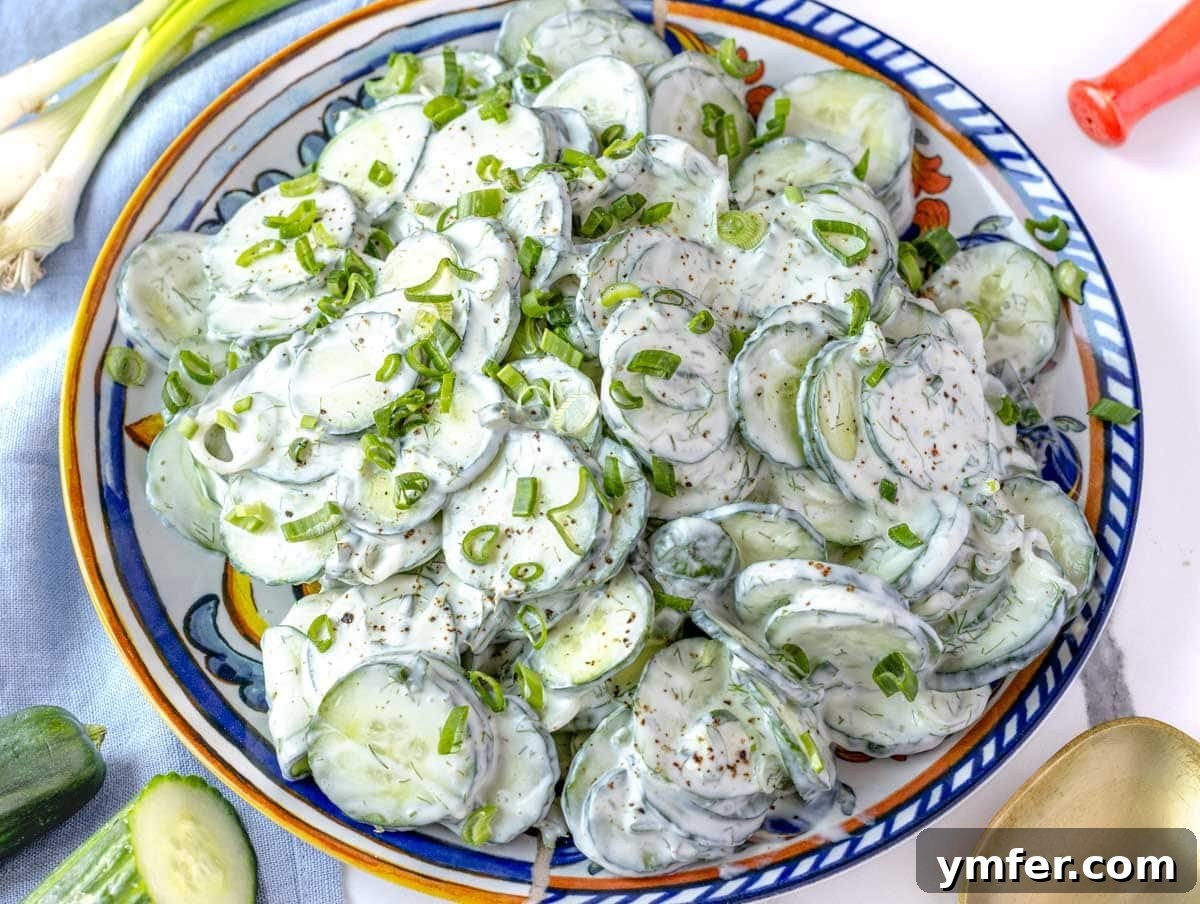 35 Stress-Free Dinner Recipes 28 Creamy cucumber salad on a plate with scallions on the side, a refreshing accompaniment