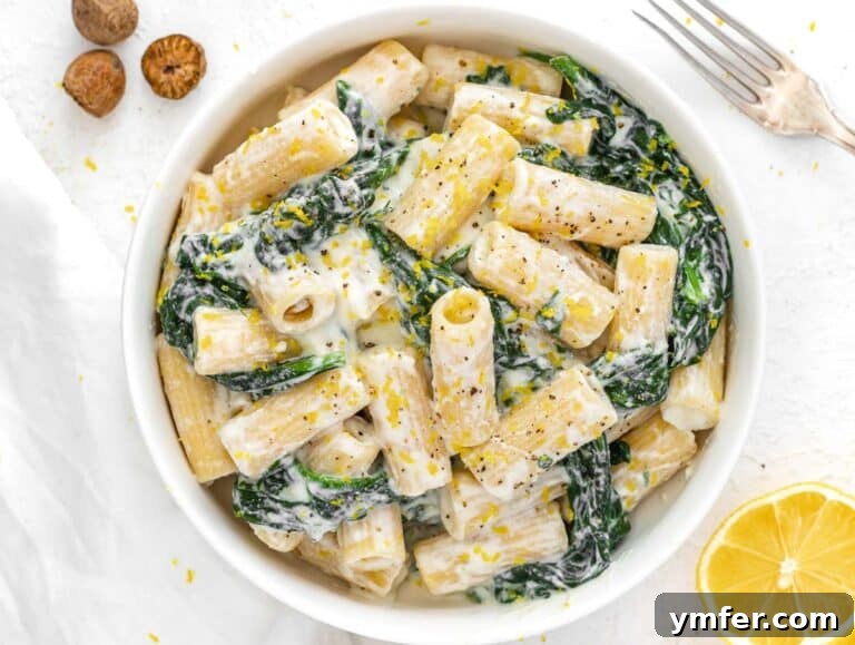 35 Stress-Free Dinner Recipes 33 Spinach and ricotta pasta being tossed with a fork in a bowl