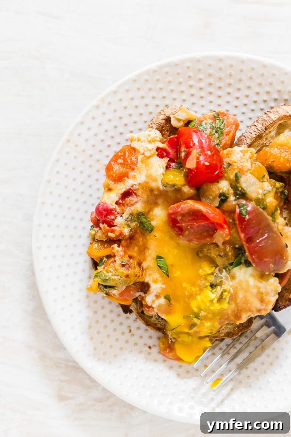 Rustic Bruschetta Egg Bake 2 Bruschetta Baked Eggs on a plate, garnished with fresh basil.