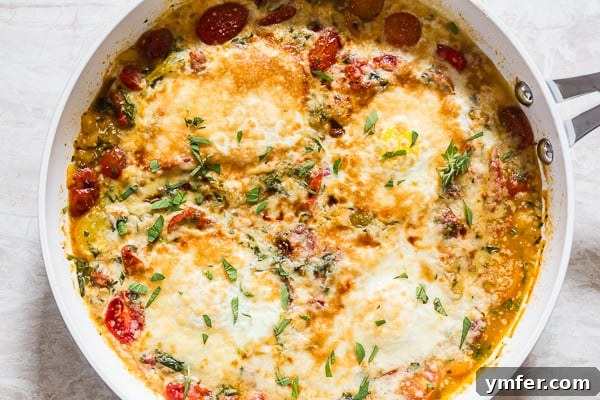 Rustic Bruschetta Egg Bake 6 Bruschetta Baked Eggs served in a skillet, garnished with fresh basil leaves.