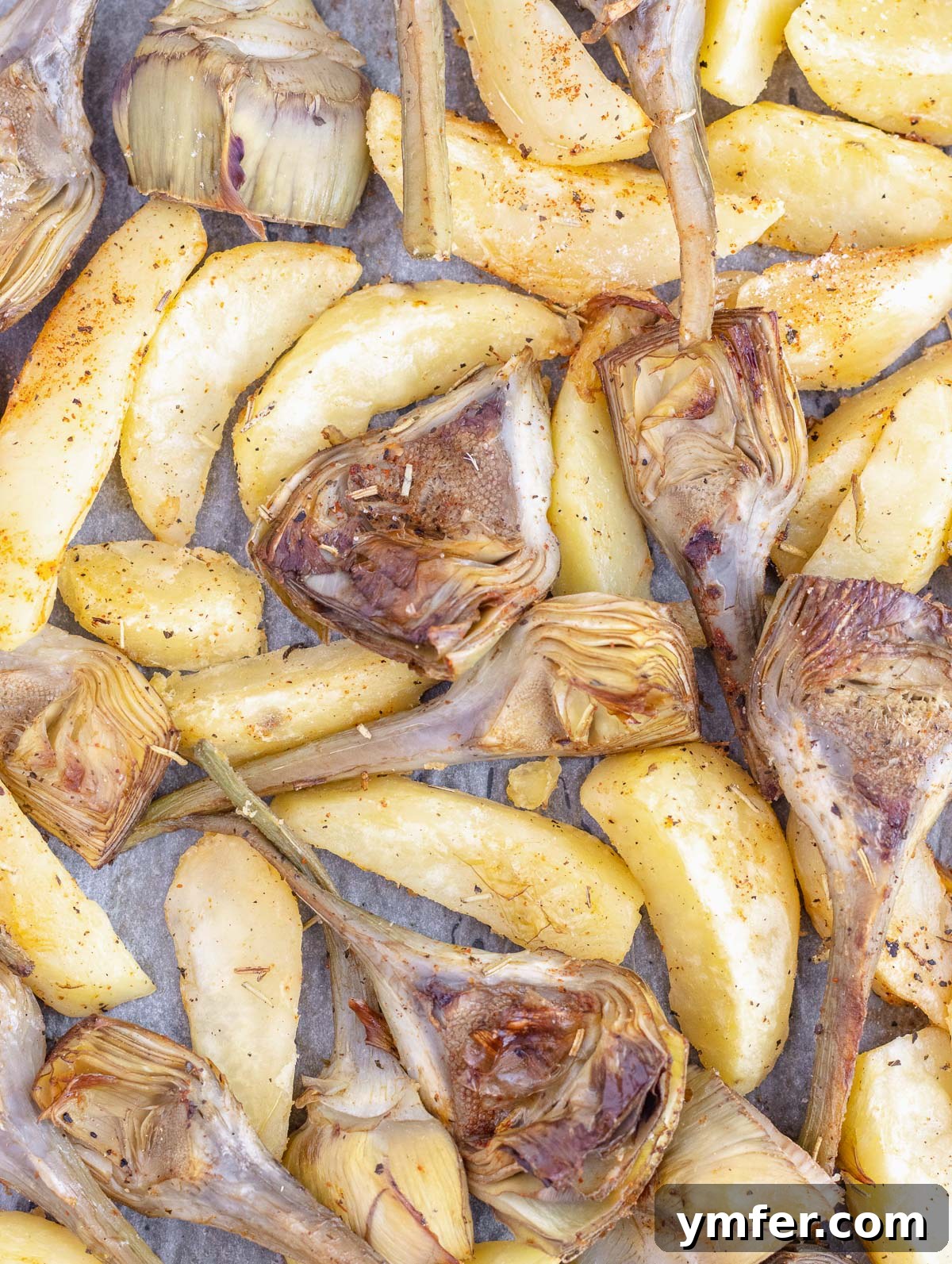 Roasted artichokes in the oven with potatoes, ready to be served