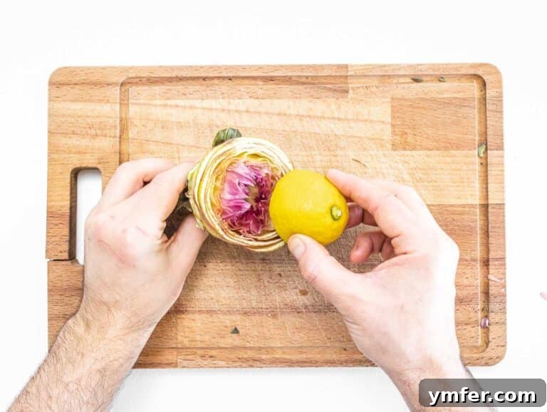 Rome's Signature Artichokes 20 Lemon being rubbed on the cut surface of an artichoke by hands