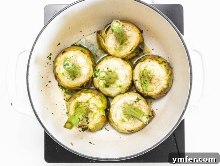 Rome's Signature Artichokes 28 Artichokes simmering in a pot with wine and water