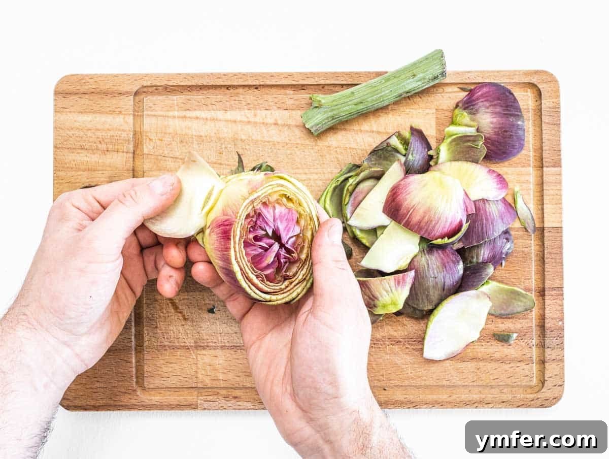 Rome's Signature Artichokes 7 Hands removing outer leaves from an artichoke