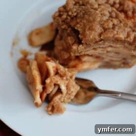 Spiced Apple Crumble Bake 2 A freshly baked apple crisp pie with a golden, crumbly topping, ready to be served.