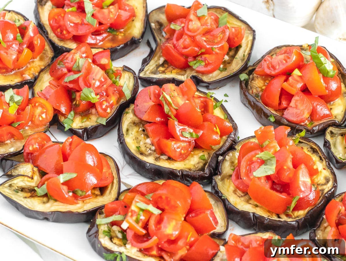 30 Crowd-Pleasing Vegan Starters 10 Mini eggplant pizzas adorned with fresh tomatoes and herbs.