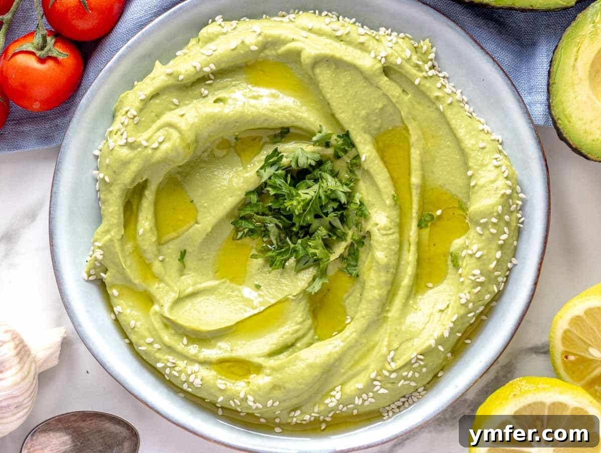 30 Crowd-Pleasing Vegan Starters 19 Creamy avocado spread presented beautifully on a blue plate, with lemon slices on the side.