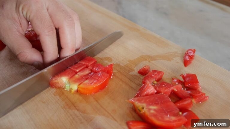 30 Crowd-Pleasing Vegan Starters 24 chopping the tomatoes with a serrated knife