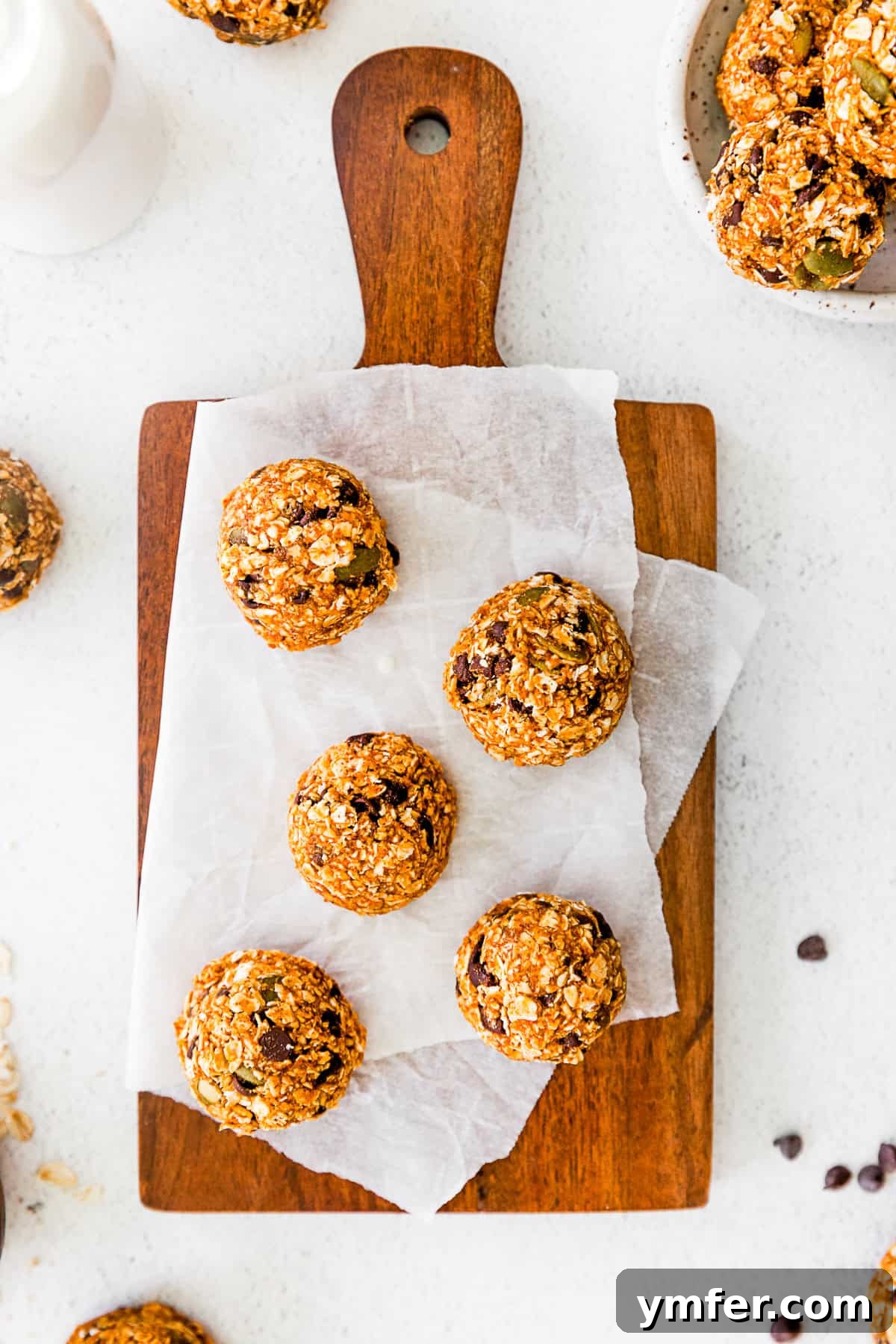 Pumpkin Energy Balls on a wooden cutting board, ready to be enjoyed.