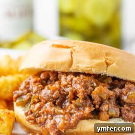 Homemade Sloppy Joes on a soft bun with a side of tater tots.