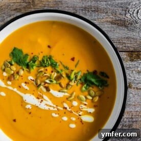 This spicy Thai pumpkin soup is ready in just 30 minutes and is packed full of flavor. It's super creamy and made with coconut milk, curry paste and tons of other Thai inspired flavors. Serve with all the toppings and devour!