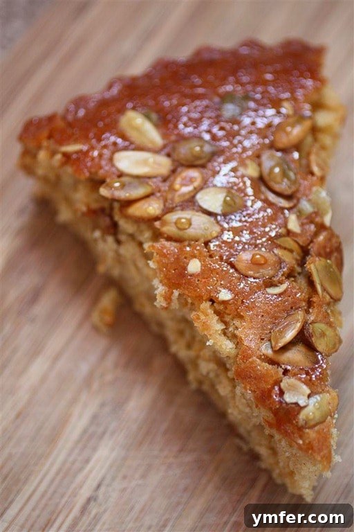 Pumpkin Butter Honey Cake by Nutmeg Nanny Slice of Pumpkin Butter Honey Cake showing its moist texture and rich color.